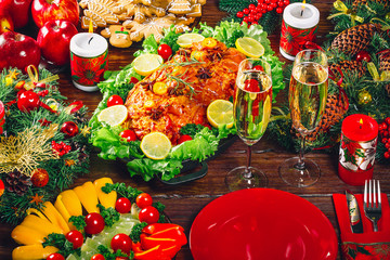 Christmas table dinner time with roasted meats, candles and New Year décor. Background thanksgiving. The concept of a family holiday, Beautiful delicious food
