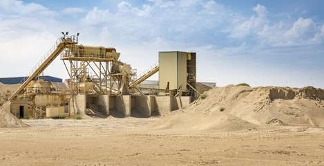 site of sand extraction with machinery and supply bays