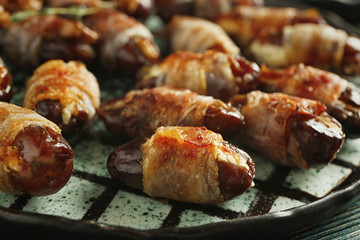 Plate with bacon wrapped dates, closeup
