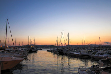 Fototapeta na wymiar Numerous yachts in a Spanish port in the Costa Brava during sunset