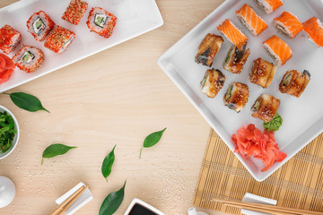 Fototapeta na wymiar Composition with tasty sushi rolls on table