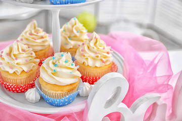 Delicious cupcakes on stand, closeup