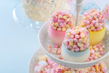 Fototapeta na wymiar Delicious marshmallow desserts on stand, closeup