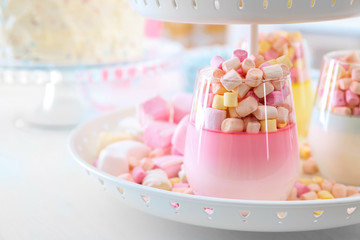 Delicious marshmallow desserts on stand, closeup