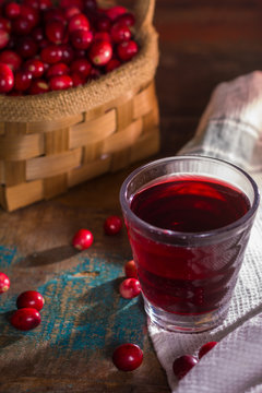 Glass with red cranberry juice or drink, ingredients for cocktsils, vitamin C, natural flu remedy