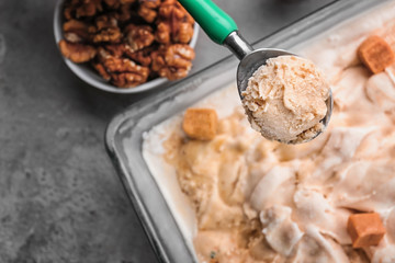 Spoon with delicious ice cream, closeup