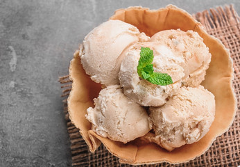 Delicious ice cream in waffle bowl on table, closeup