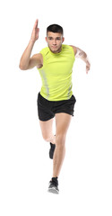 Young man in sportswear running against white background