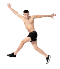 Handsome young man running against white background