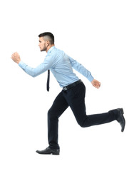 Young man in formal clothes running against white background