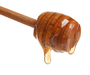 Fototapeta premium Honey dripping from dipper on white background