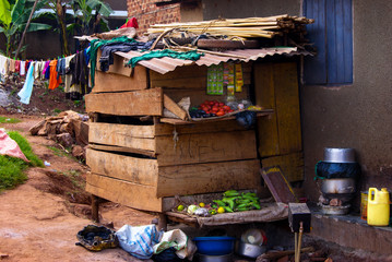 Small self built african shop shed where all sorts of goods are on display. People trying to make a...