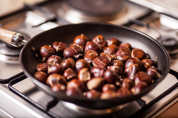 Roasted chestnuts on frying pan. Top view.