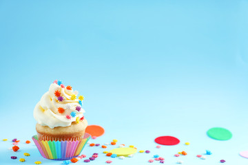 Tasty cupcake on color background
