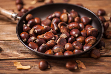 Roasted chestnuts on frying pan. Top view.