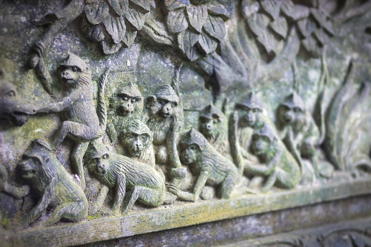 Fragment of bas-relief featuring monkeys on Padangtegal Great Temple of Death (Pura Dalem Agung Padangtegal) in the Sacred Monkey Forest of Padangtegal, Ubud, Bali, Indonesia