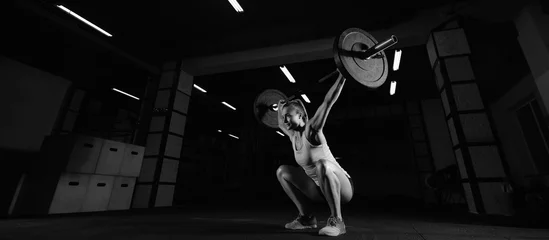 Fotobehang Female fitness athlete exercising © IEGOR LIASHENKO