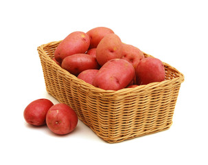 fresh potatoes in a basket isolated on white