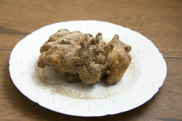 Apple fritter on white china plate