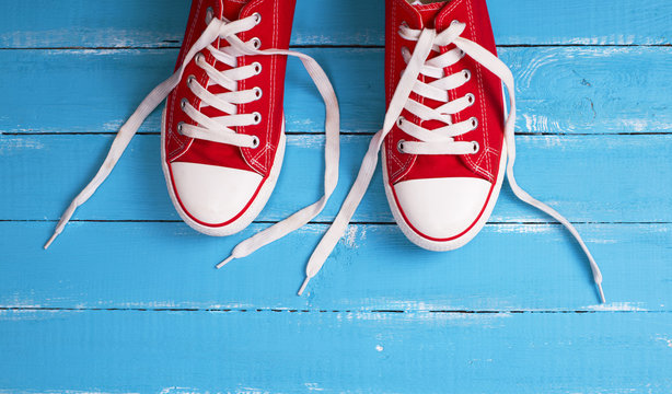 pair of red  sneakers with white laces