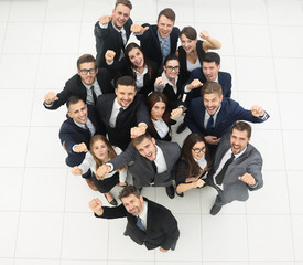 concept of success. business team raising hands and looking at camera.