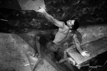 Workout exercise. Indoor climbing gym. Active man exercising.