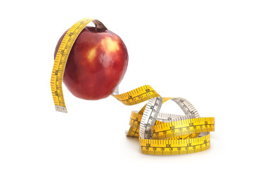 Red apple and measuring tape isolated on white background