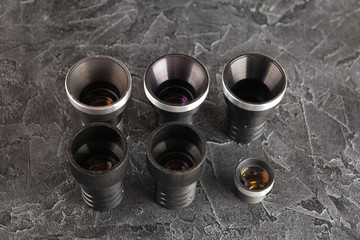 Old lenses on a dark concrete background. Black texture of cement.
