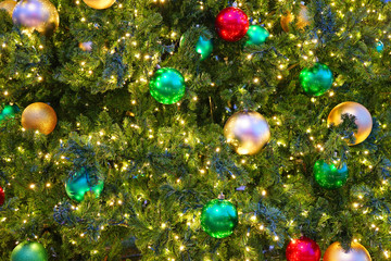 Fototapeta na wymiar Red and green holiday ornaments on a Christmas tree