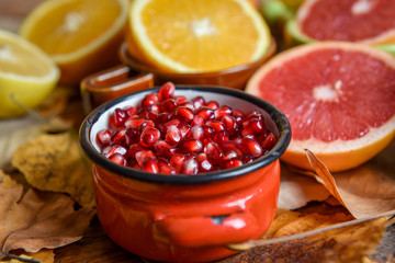 Tropical fruits with mix of lemons, oranges, grapefruit, pomegranate on a vintage wooden board