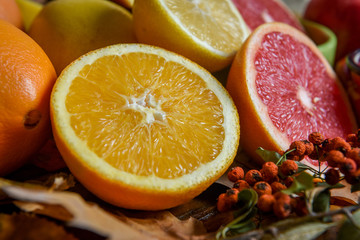 Fototapeta na wymiar Mix of tropical fruits with lemon, orange, grapefruit, pomegranate on a vintage wooden board
