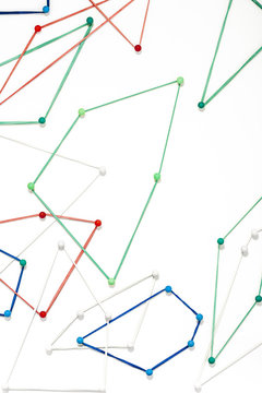 Pins and rubber bands against white background
