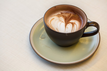 cup of coffee on wooden background