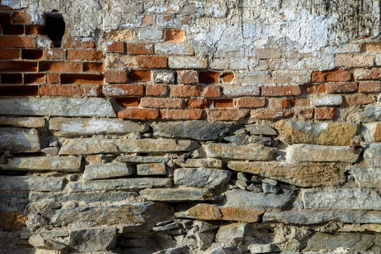 Old brick wall texture. Grunge background of aged stone surface © SergeyCash