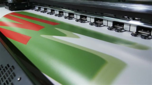 Closeup Motion to Printer Machine Making Green Red Picture