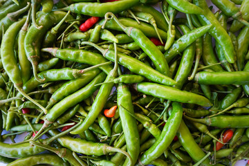 Top view red green chili pepper ingredient for Tom Yum Chili hot spicy soup thai food on wooden background