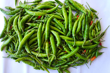 Top view red green chili pepper ingredient for Tom Yum Chili hot spicy soup thai food on wooden background