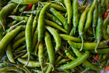 Top view red green chili pepper ingredient for Tom Yum Chili hot spicy soup thai food on wooden background