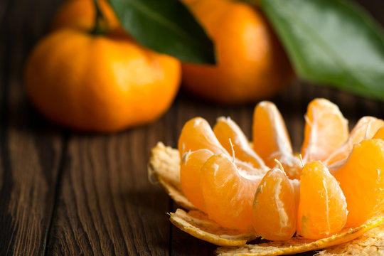 Peeled Mandarin slices on a wooden table