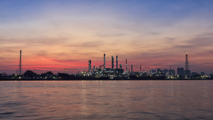 Obraz premium oil refinery along the river at sunrise