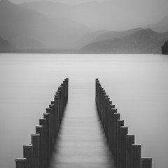 Poles in the water on a rainy day at lake Chuzenji in Nikko, Tochigi Prefecture, Japan