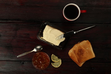 cup of coffee toast with butter on wooden table
