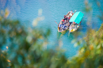 Tourists enjoying a riverside view while riding on the river at Arashiyama