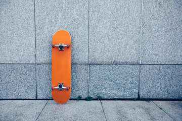 one skateboard against gray wall © lzf