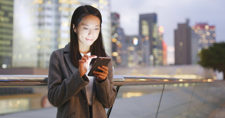 Young Business woman use of smart phone at night