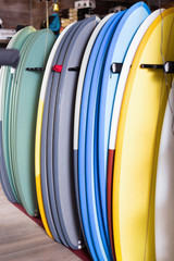 Image of colorful surfboard standing in store