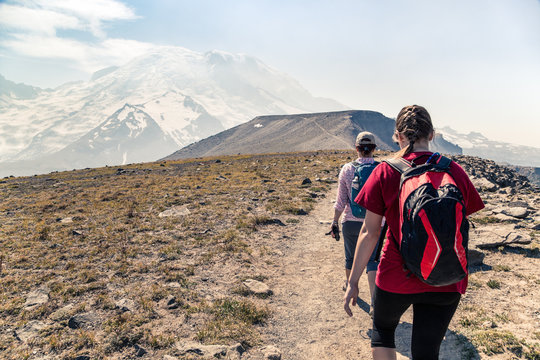 Two women hiking along an alpine trail, Mt Rainier, Washington, America, USA