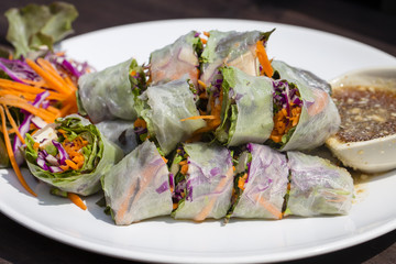 Fresh vietnamese spring rolls on a plate with salad