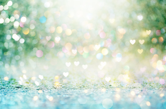 Beautiful shiny hearts and abstract lights background
