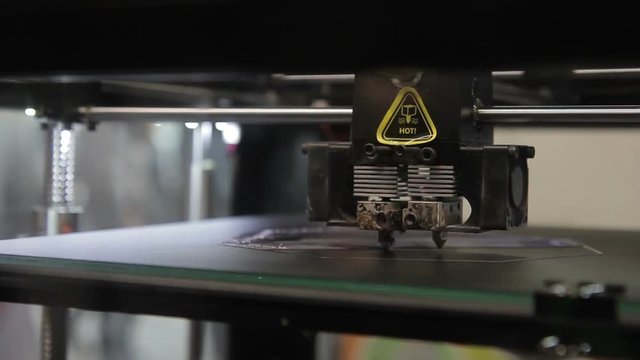 On working platform 3d of printer printhead moves along axes. Innovative equipment is tested using uniform plastic layers for production of three-dimensional parts.